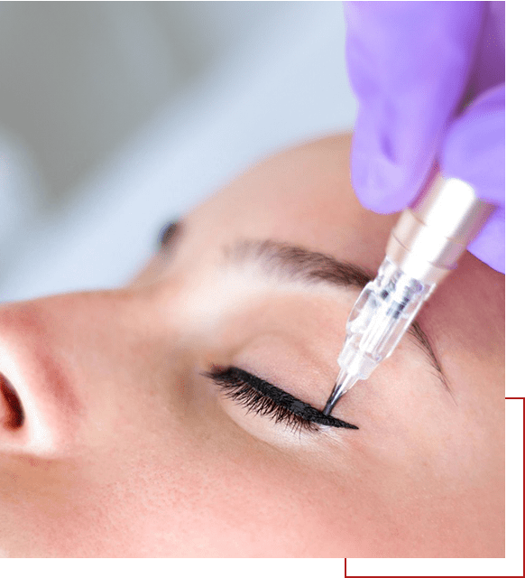 A woman is getting her eyelashes tattooed